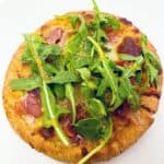 Prosciutto and Arugula are the toppings for this personal sized pizza made on a pita bread