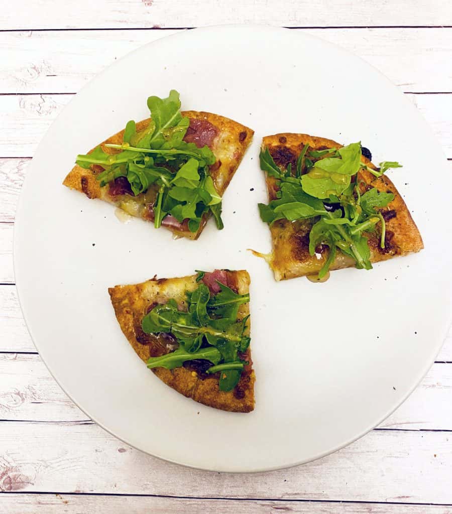 Prosciutto and Arugula are the toppings for this personal sized pizza made on a pita bread