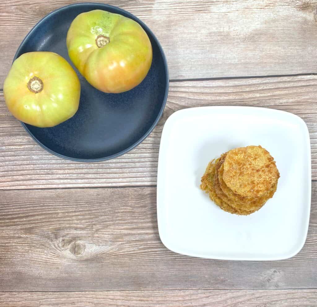 overhead shot of fried green tomatoes stacked on a white plate