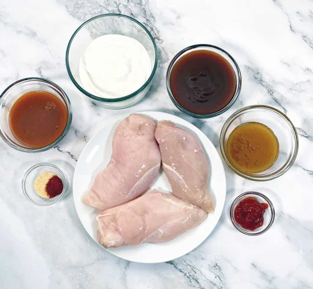 chicken breasts surrounded by ingredients for spicy bbq sauce