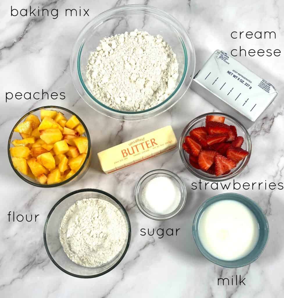 ingredients for peach and strawberry breakfast braid laid out: peaches, strawberries, milk, butter, cream cheese, sugar, flour and baking mix