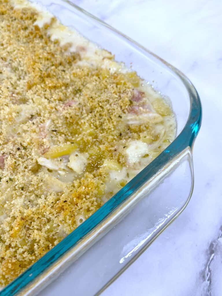 chicken cordon bleu macaroni and cheese in glass casserole dish