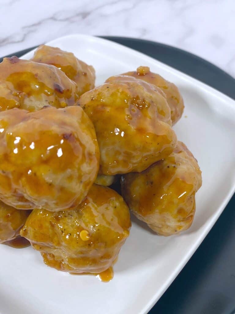 top view of firecracker chicken meatballs on a white plate