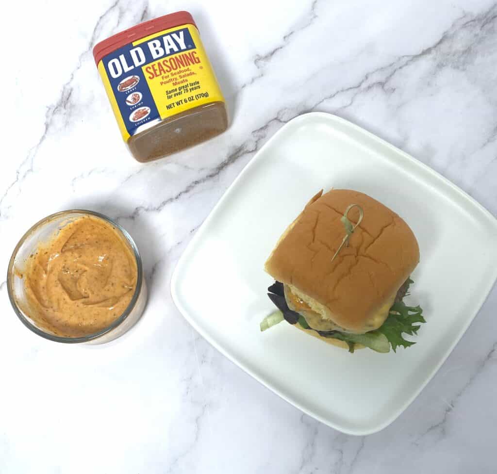 old bay burger, with old bay burger sauce and can of old bay 