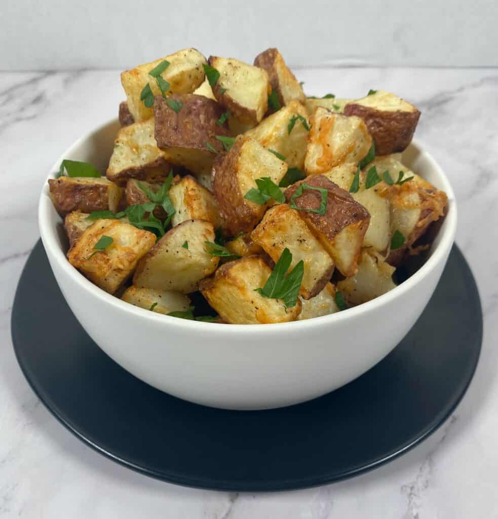 parmesan parsley roasted potatoes in white bowl