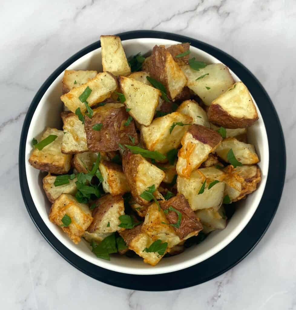 parmesan parsley roasted potatoes in white bowl