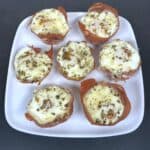 prosciutto egg cups on white plate