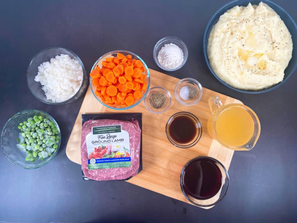 Ingredients for traditional irish shepherd’s pie - ground lamb, carrots, peas, onion, seasonings, stock and mashed potatoes. 