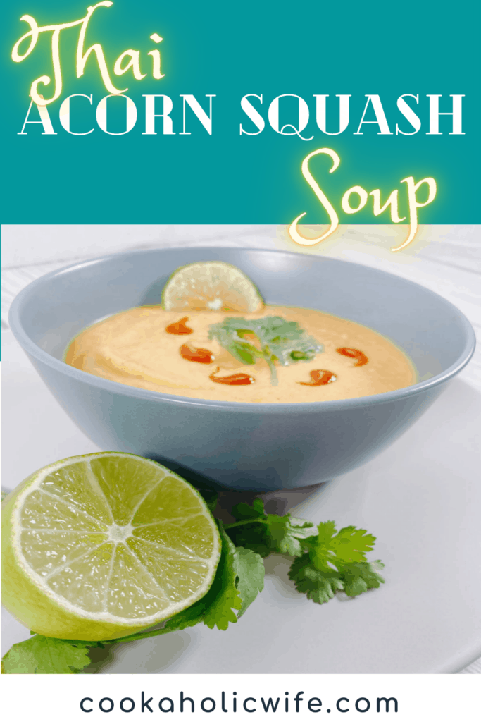 thai acorn squash soup pureed in bowl, garnished with cilantro leaves and sriracha