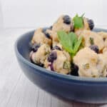 bowl of blueberry chicken meatballs with fresh basil leaves