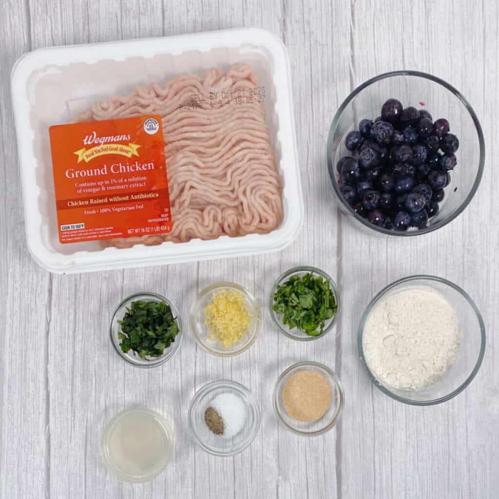 ingredients for blueberry chicken meatballs - ground chicken, blueberries, fresh basil, fresh mint, flour, seasonings