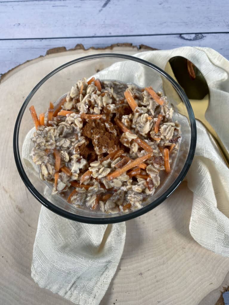 carrot cake overnight oats in a glass bowl 