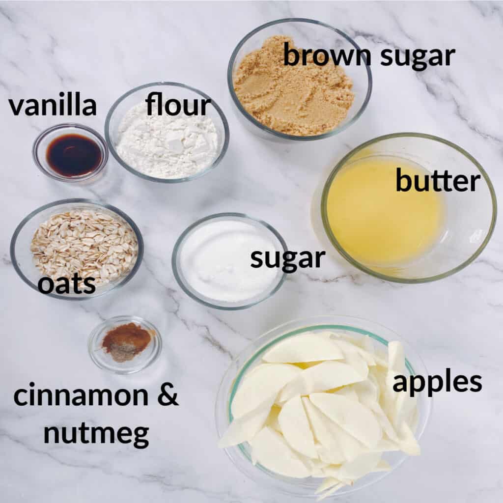 ingredients for old fashioned apple crisp - peeled and sliced apples, melted butter, flour, sugar, brown sugar, oats, vanilla, cinnamon and nutmeg