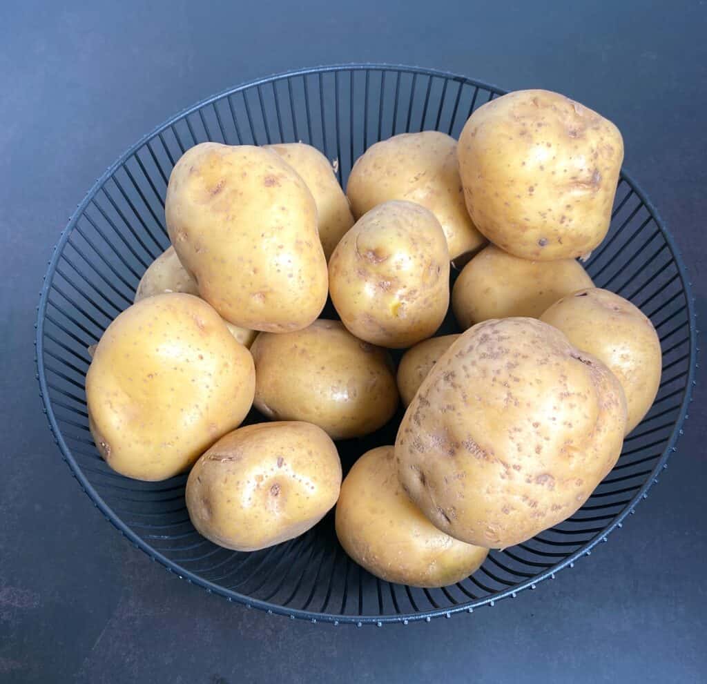 a blue bowl of yukon gold potatoes 