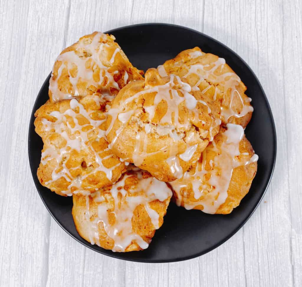 A plate stacked high with air fryer apple fritters