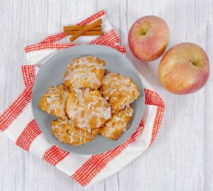 A plate stacked high with air fryer apple fritters