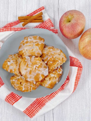 A plate stacked high with air fryer apple fritters