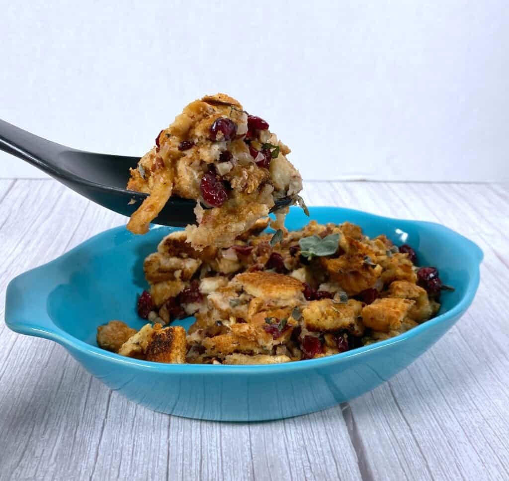 cranberry pecan stuffing lifted on a spatula