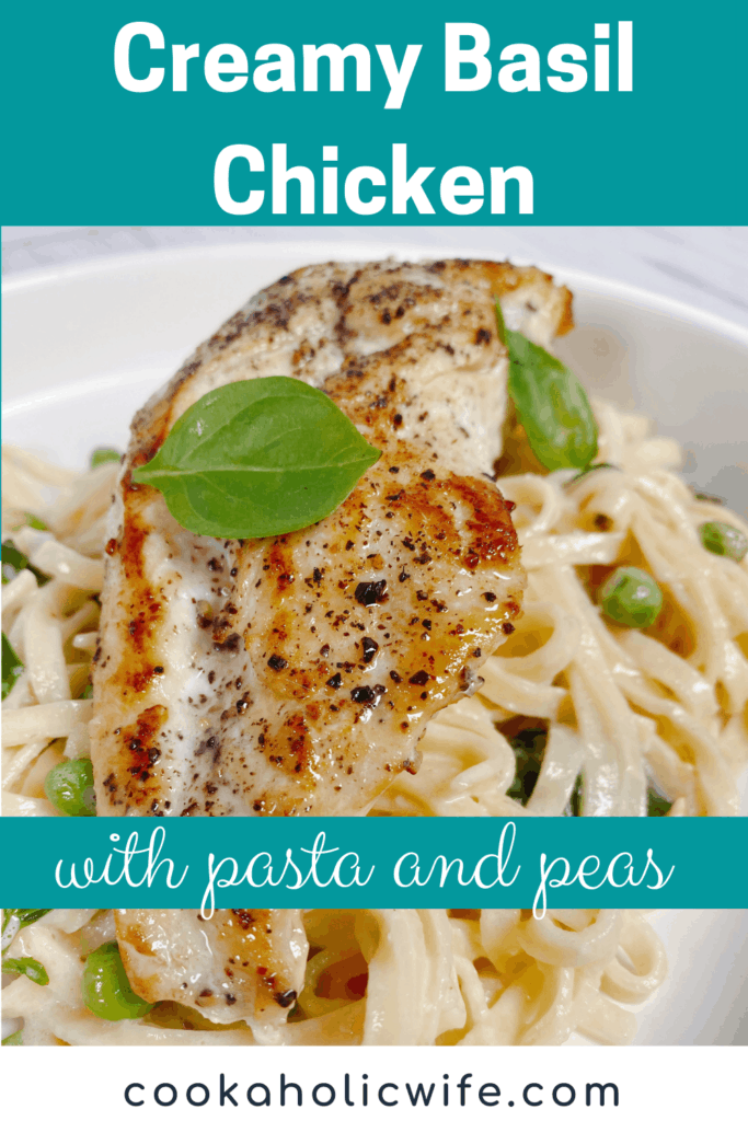 a pan-fried chicken breast sits on top a pile of creamy pasta with fresh basil and peas mixed in