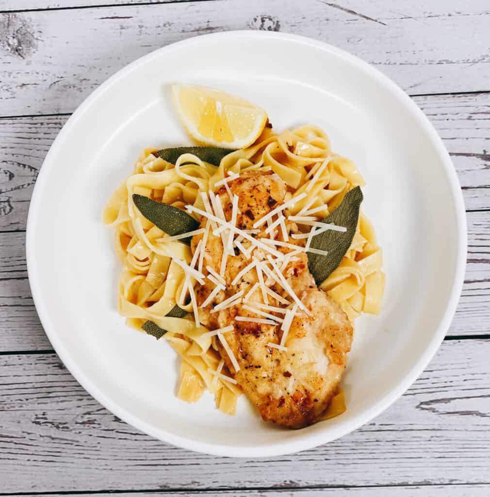 sage butter chicken pasta in a white bowl