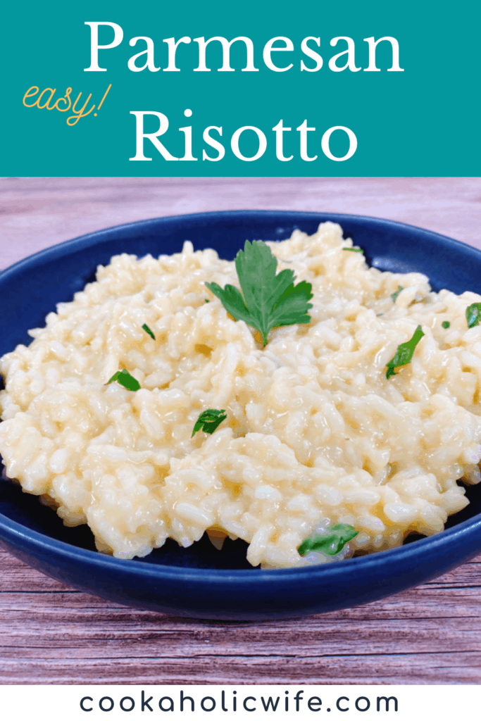 creamy parmesan risotto sprinkled with fresh parsley sits in a dark blue bowl on a wooden background