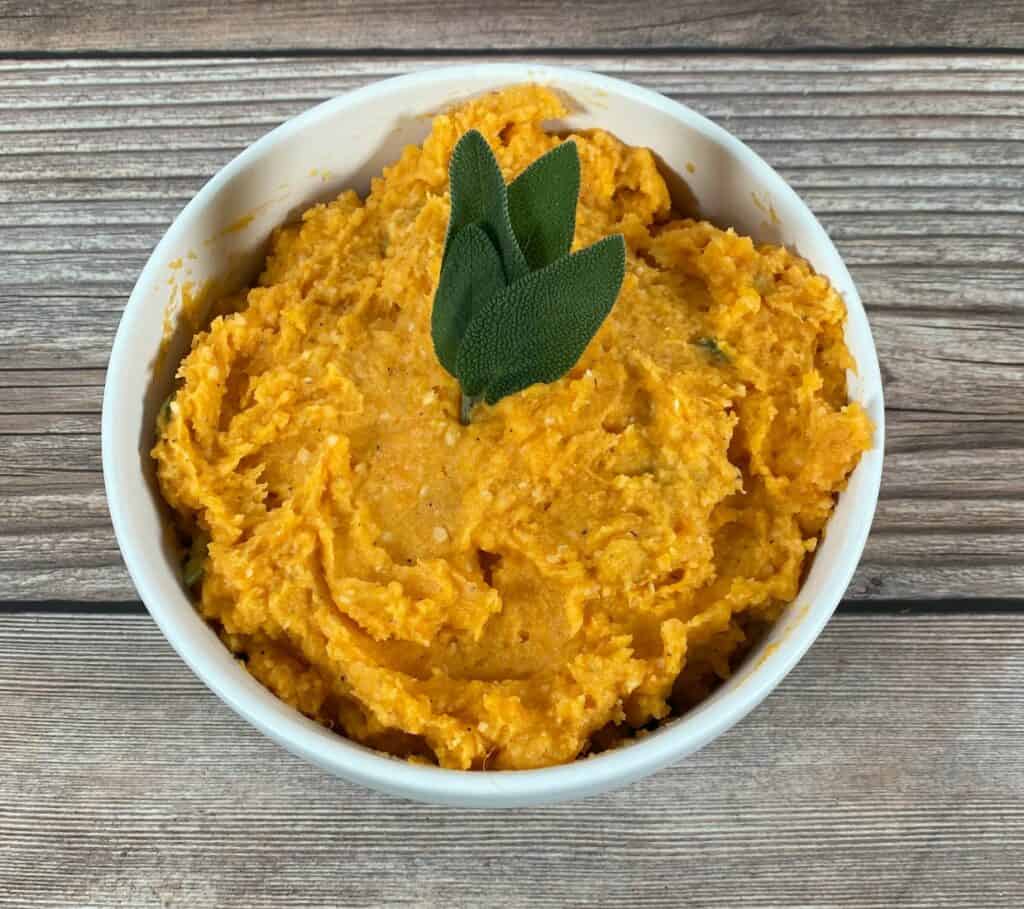 overhead image of sweet potatoes with fresh sage leaves on top