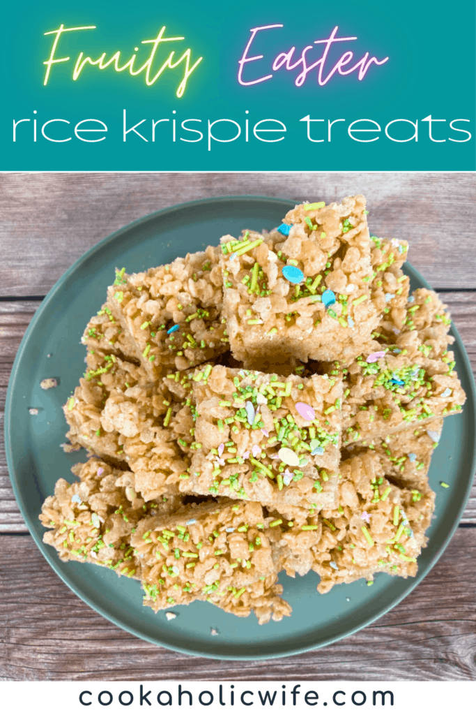 a pile of fruity easter rice krispies sits on a pale green plate on a wooden background. the treats are covered with Easter sprinkles, pastel in color and some are in the shape of easter eggs. 