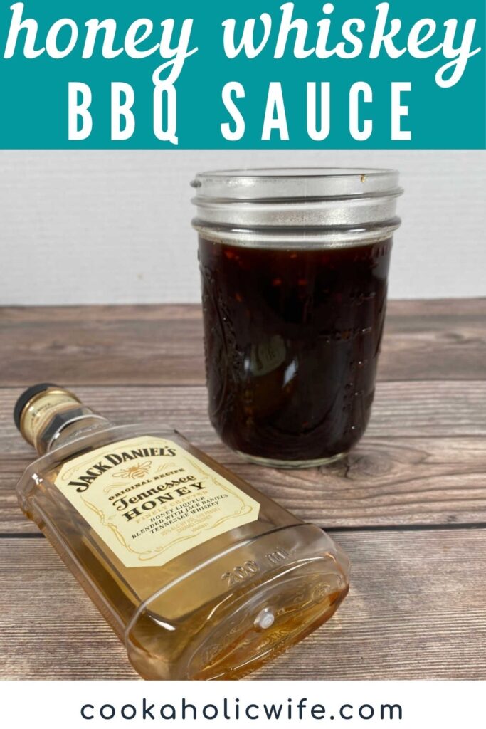 Image for Pinterest, text overlay of recipe name at the top. Image of Honey Whiskey BBQ Sauce in a mason jar with a bottle of Jack Daniels next to it. 