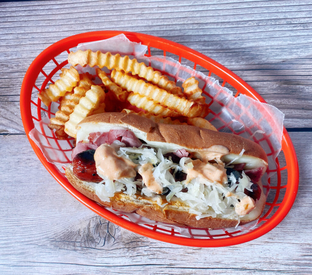 overhead image of hot dog in a red tray with fries