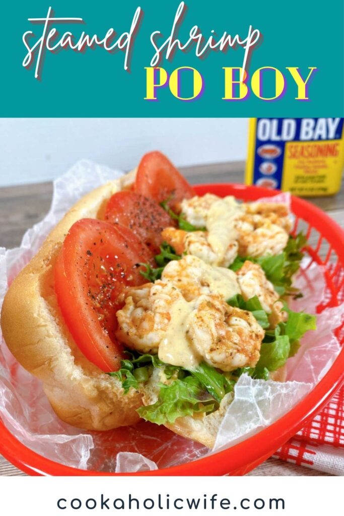 Image for Pinterest with text overlay at top and bottom. Top is the name of the recipe, bottom is the website. Image: Close up of the sandwich, showing the shrimp, sauce, tomato slices and lettuce. 