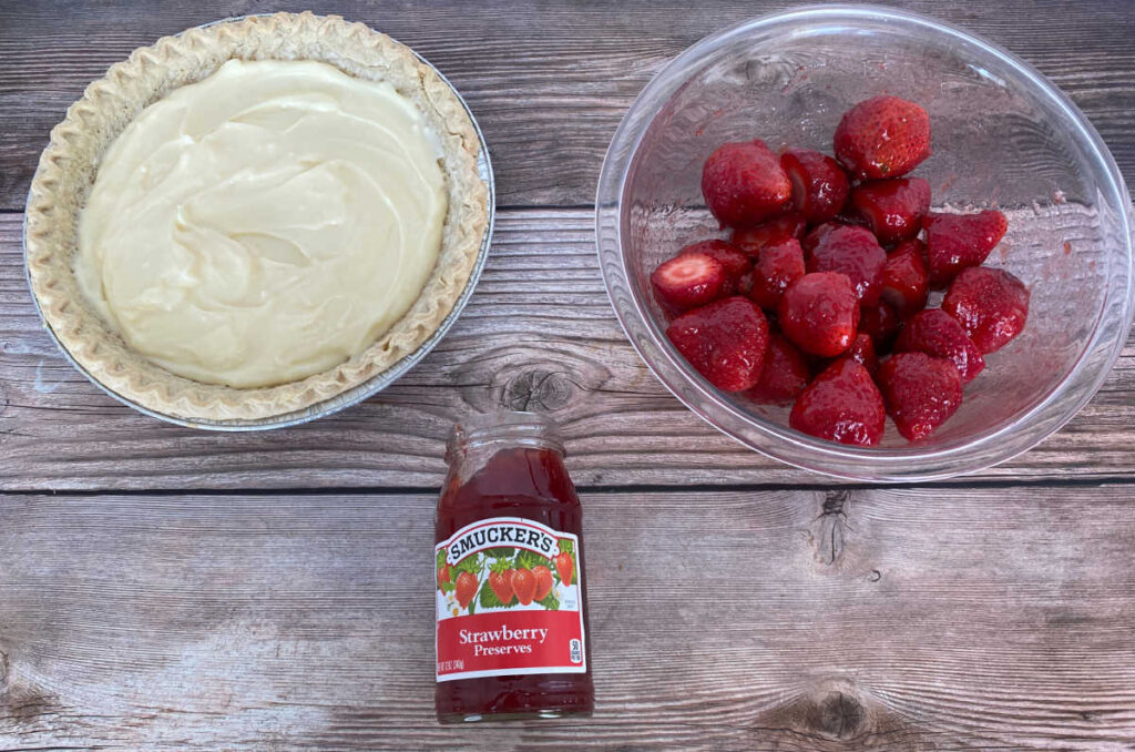 ingredients for the pie sit on a wooden background 