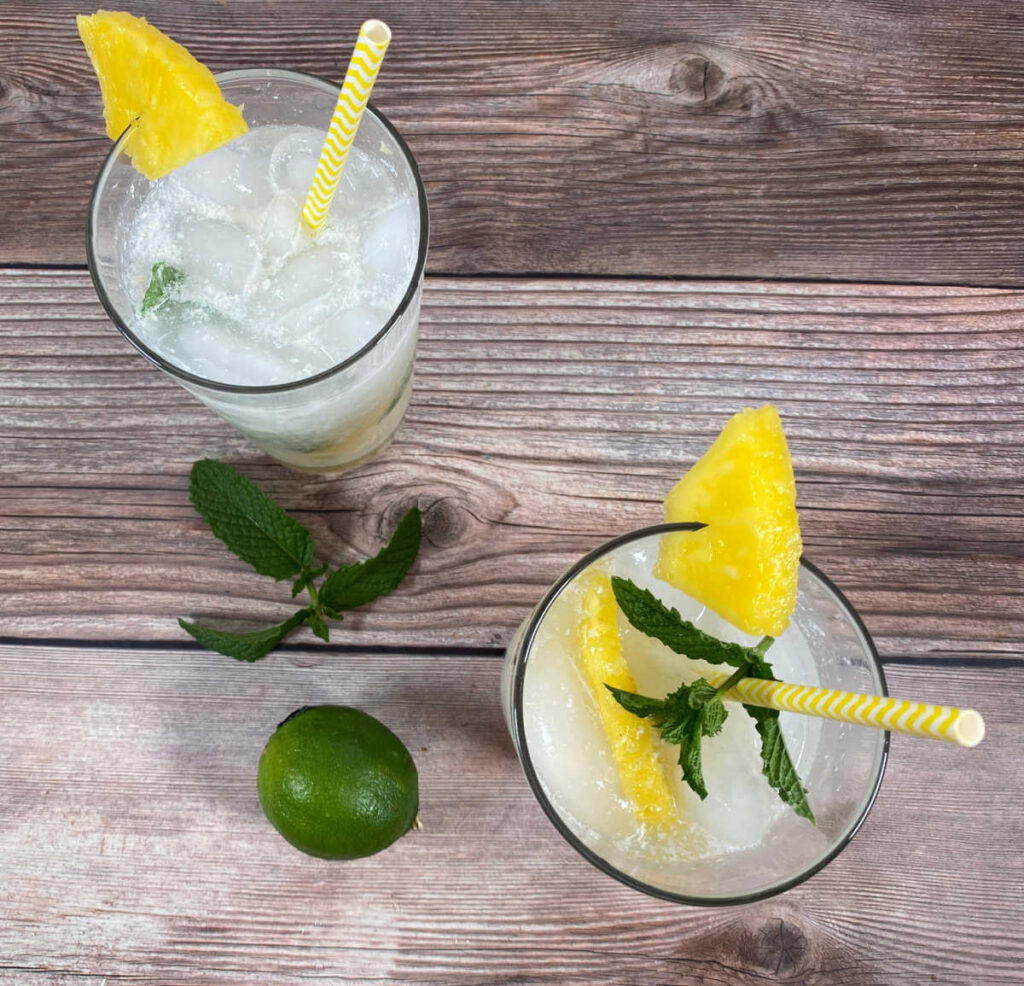 overhead view of the cocktails, mint leaves and a lime sit off to the side 