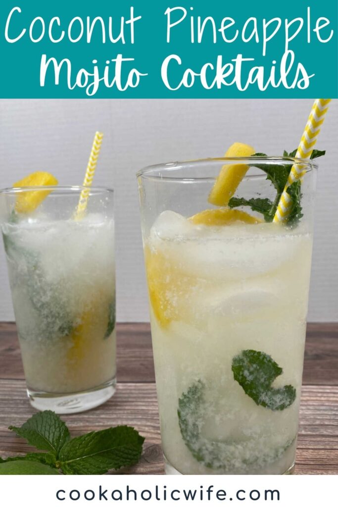 two tall glasses of coconut pineapple mojitos sit on a wooden background. Glasses are garnished with pineapple and fresh mint.