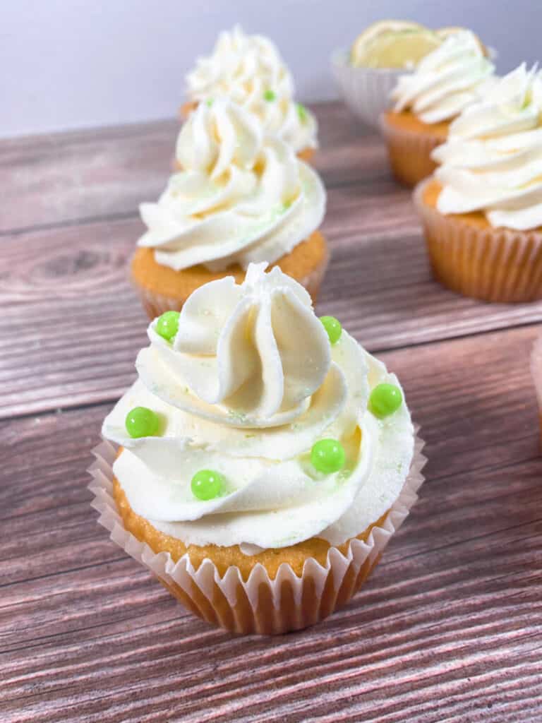 close up of the cupcake decorate with large green sprinkle balls. 