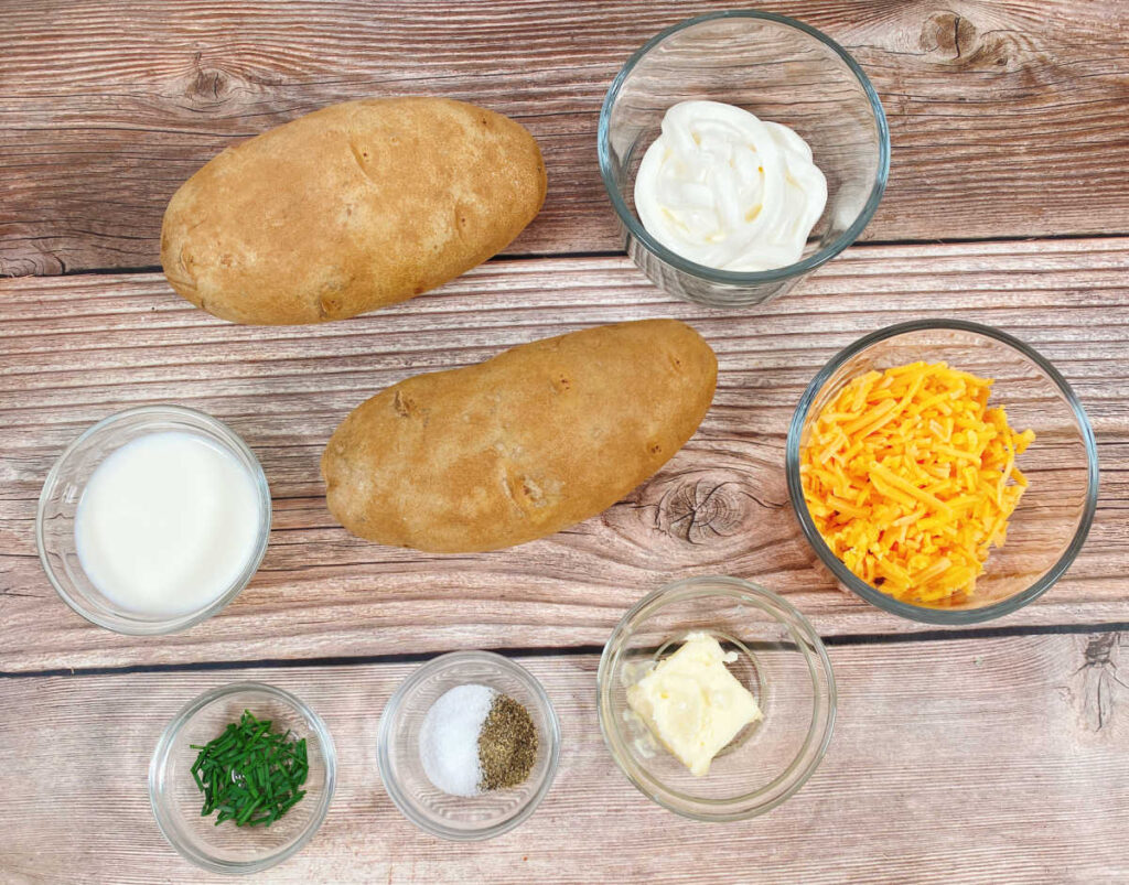 ingredients to make this recipe sit in glass bowls on a wooden background.