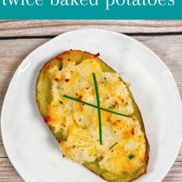 potato topped with fresh chives forming an "x" sits on a white, round plate.