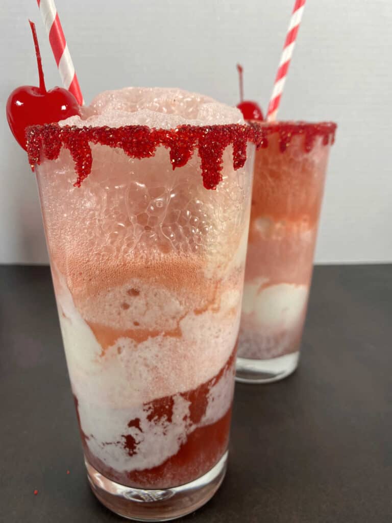 Close up of the soda and ice cream swirling together in the glasses of the floats. 