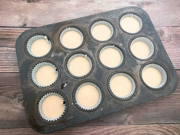 preparation image of recipe - cupcake pan filled with batter is ready to be baked. 