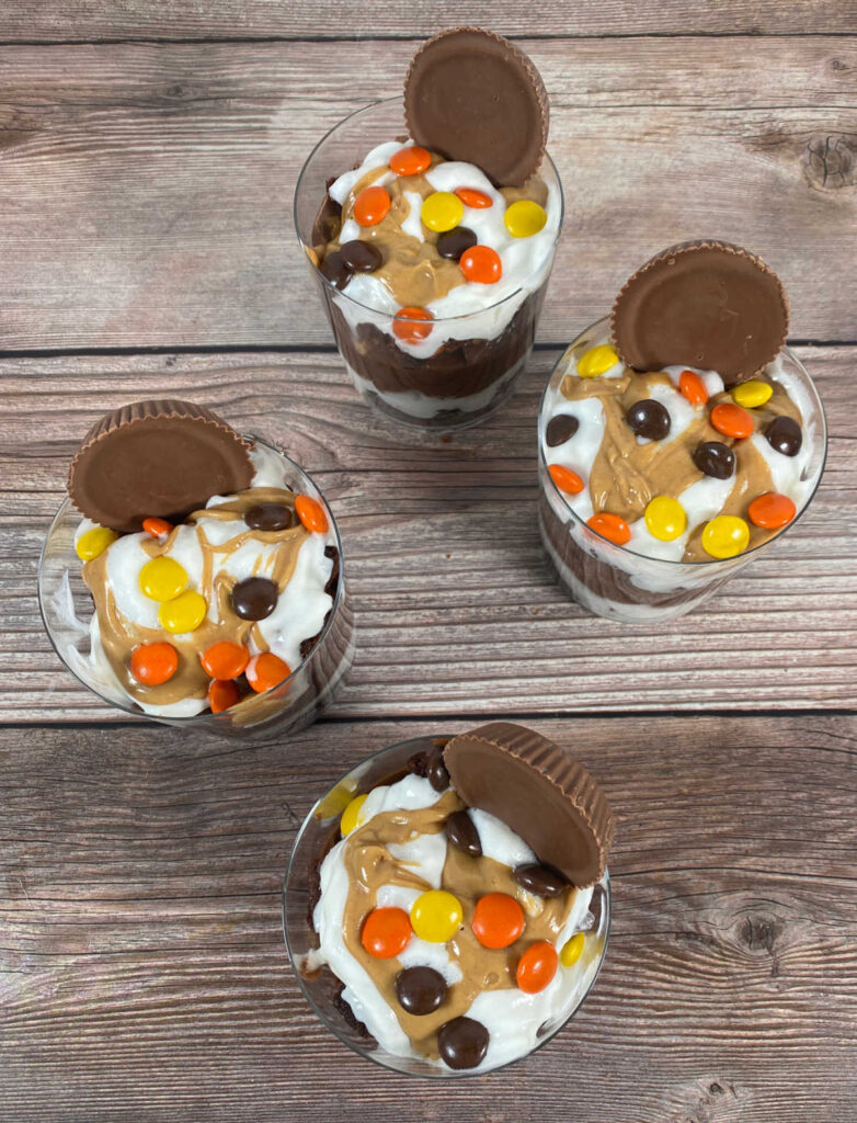 overhead image of the trifles, showing the whipped cream, peanut butter drizzle and peanut butter candies. 