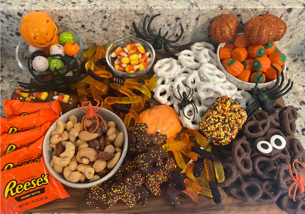 overhead view of the treat board filled with halloween candy and snacks. 