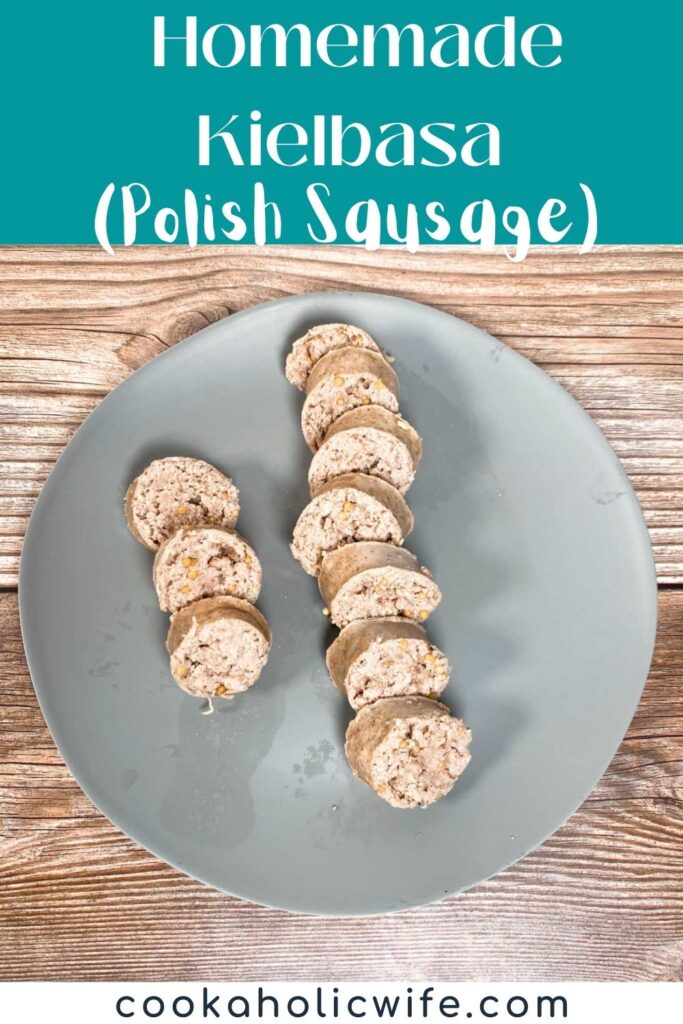 Image for Pinterest with text overlay of recipe title at the top. Sliced rounds of cooked kielbasa sit on a gray plate on a wood background. 