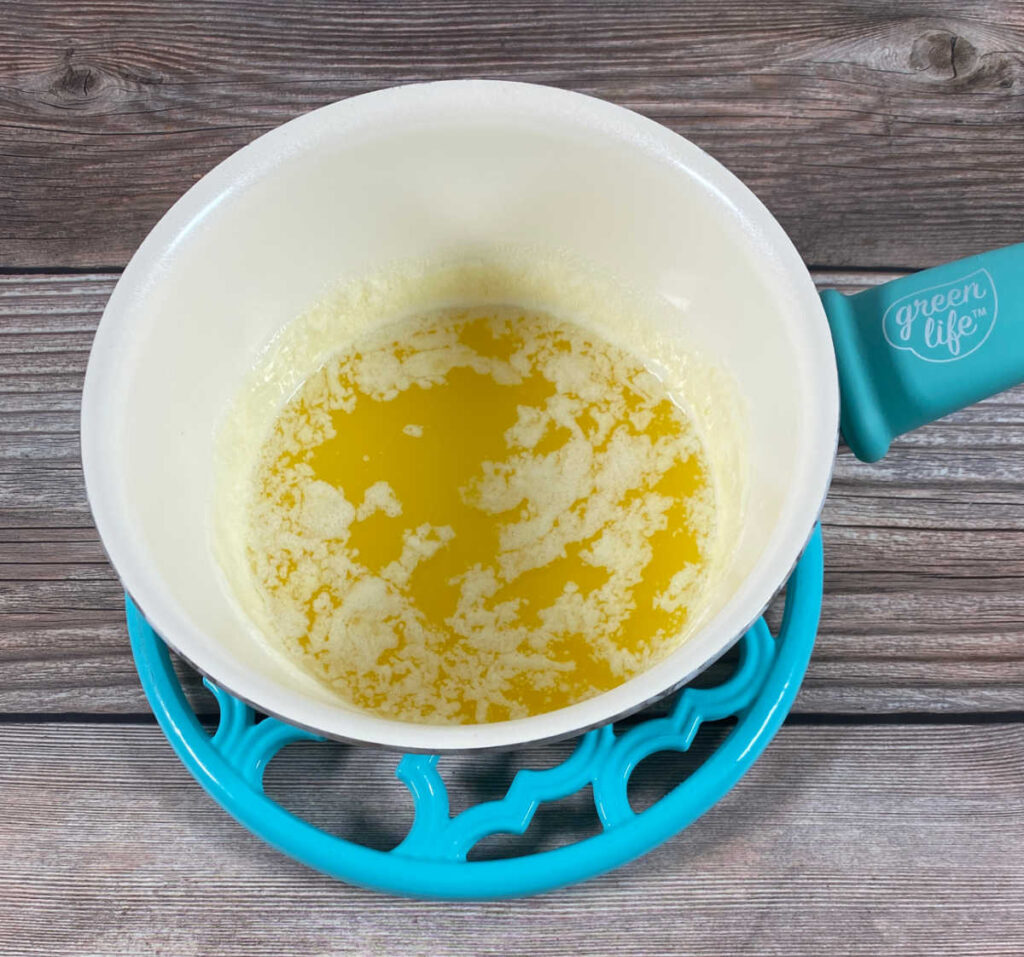 Process shot - melted butter in a skillet sits on a trivet, cooling down. 