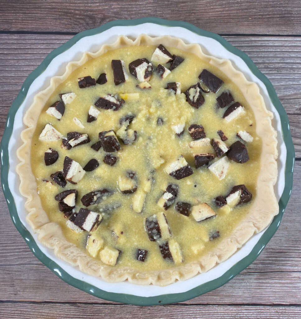 Process shot - wet ingredients and cookies are placed in the pie dough. 