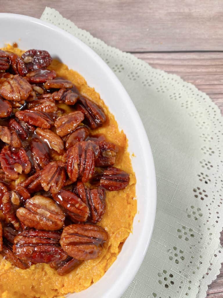 close up image of finished dish with glazed pecans contrasting against a light green napkin.