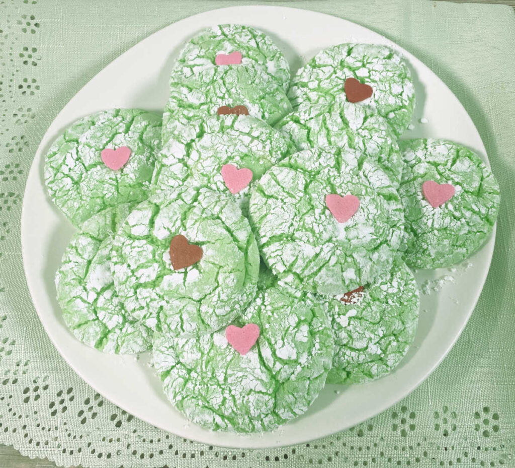 cookies sit on a round white plate on a green napkin. 