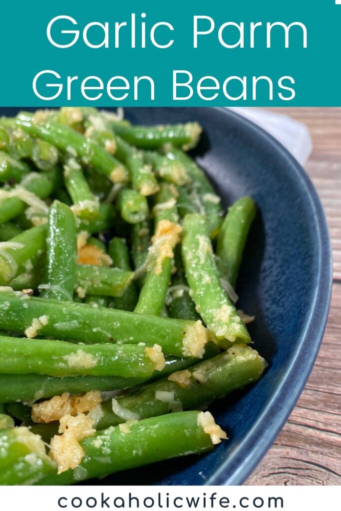 image for pinterest with title text overlay. green beans sit in a dark blue dish on a wooden background. 