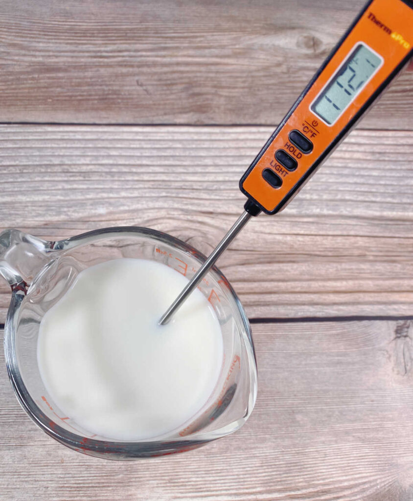 process shot - heated milk in a measuring cup, with a thermometer showing the temperature of 112 F. 