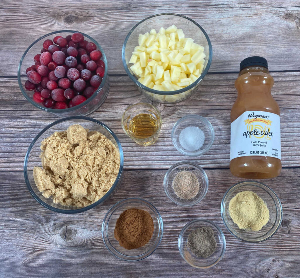 ingredients for the recipe sit in glass bowls on a wooden background.