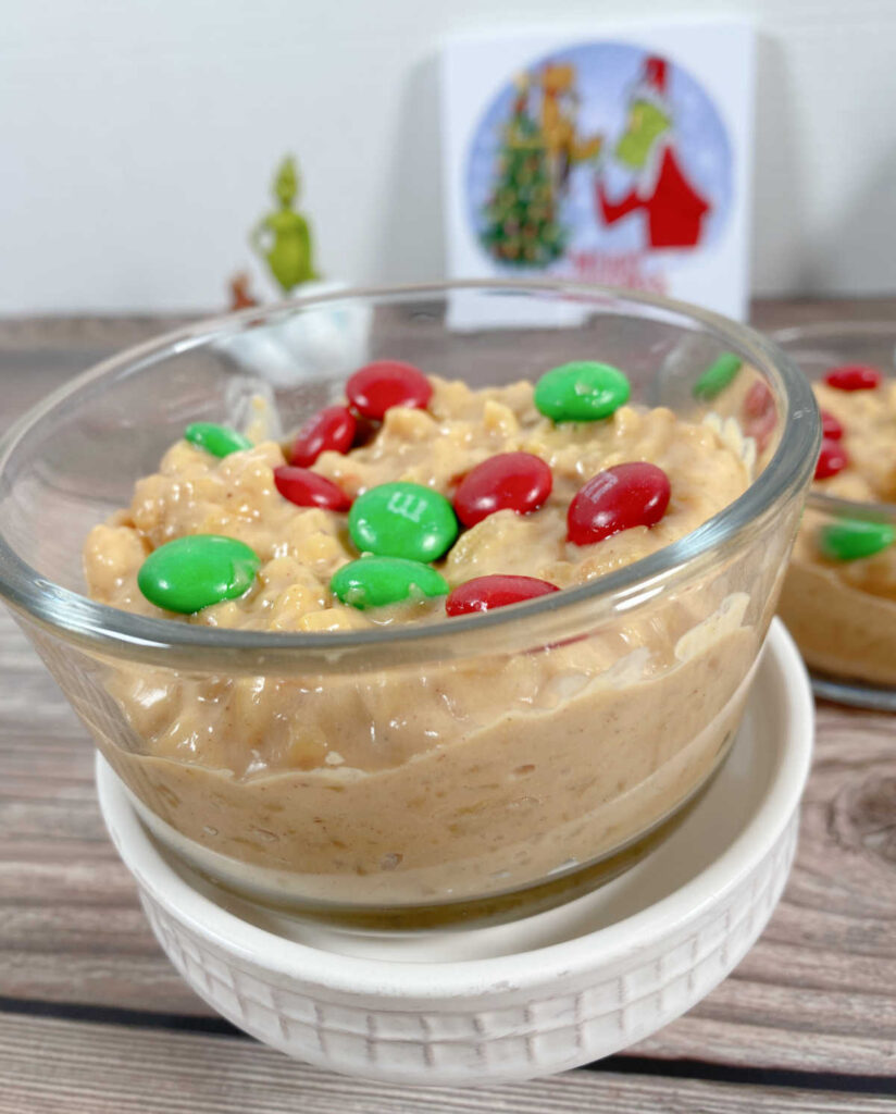 Close up image of pudding, garnished with candies, sits on a white cupcake stand. 