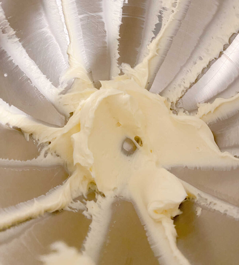 Process shot - beaten butter in the bowl of a stand mixer. 